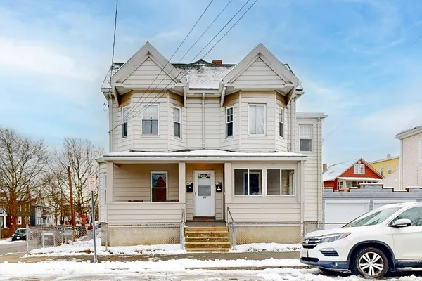 a front view of a house with parking space