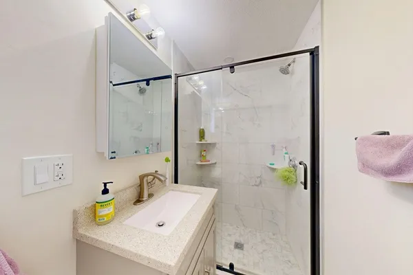 a bathroom with a sink and a shower