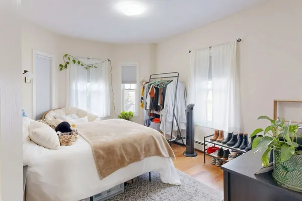 a bedroom with bed and a potted plant