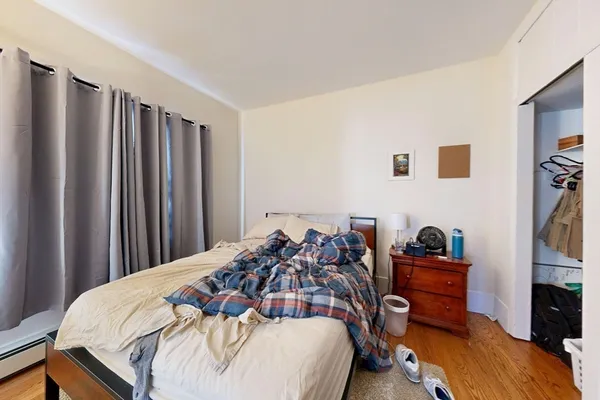a bedroom with a bed and a flat tv screen
