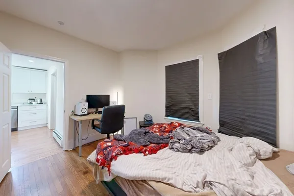 a bedroom with a bed and a television