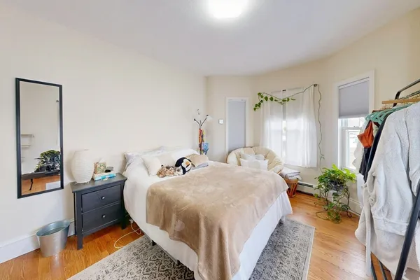 a bed room with a bed and a potted plant