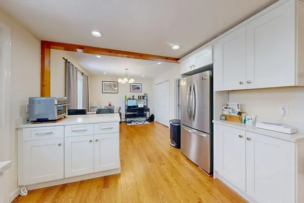 a kitchen with stainless steel appliances a refrigerator sink and cabinets