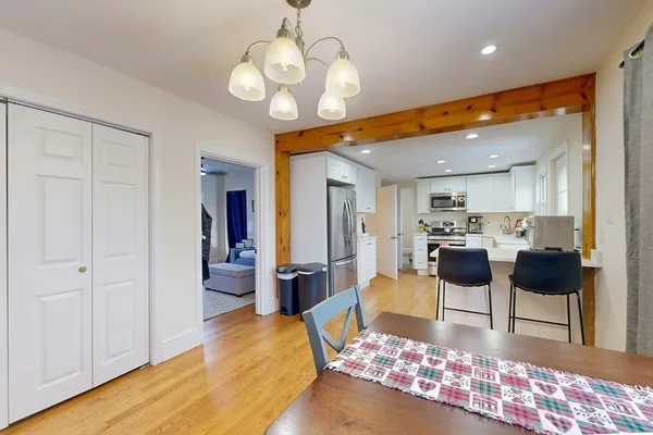 a large white kitchen with dining table and chairs