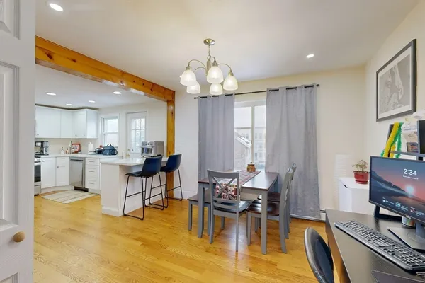 a view of a dining room with furniture and a chandelier