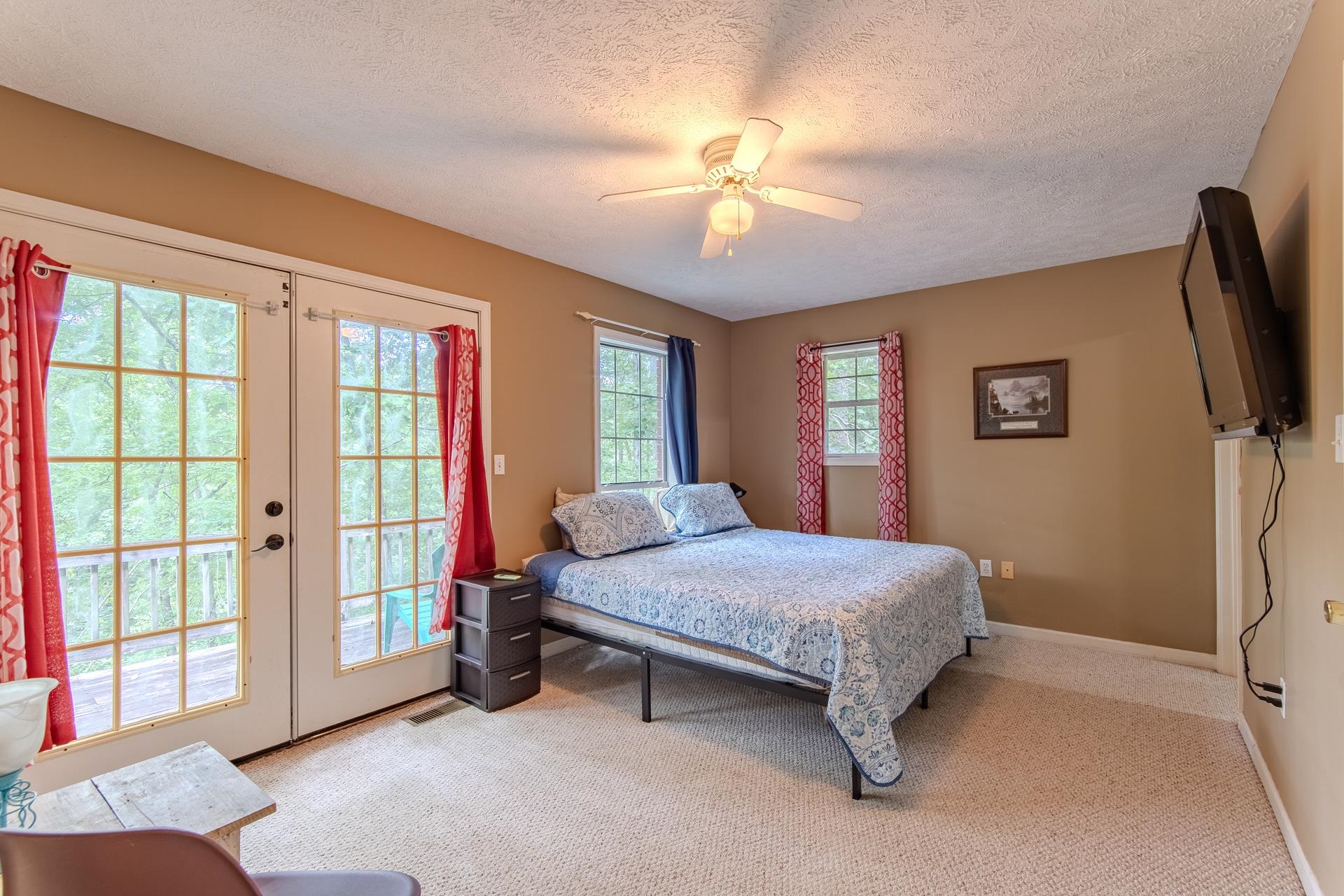 2125 Bruton Branch Road Savannah, TN 38372 - Photo 14 of 33 a bedroom with a bed and a flat screen tv