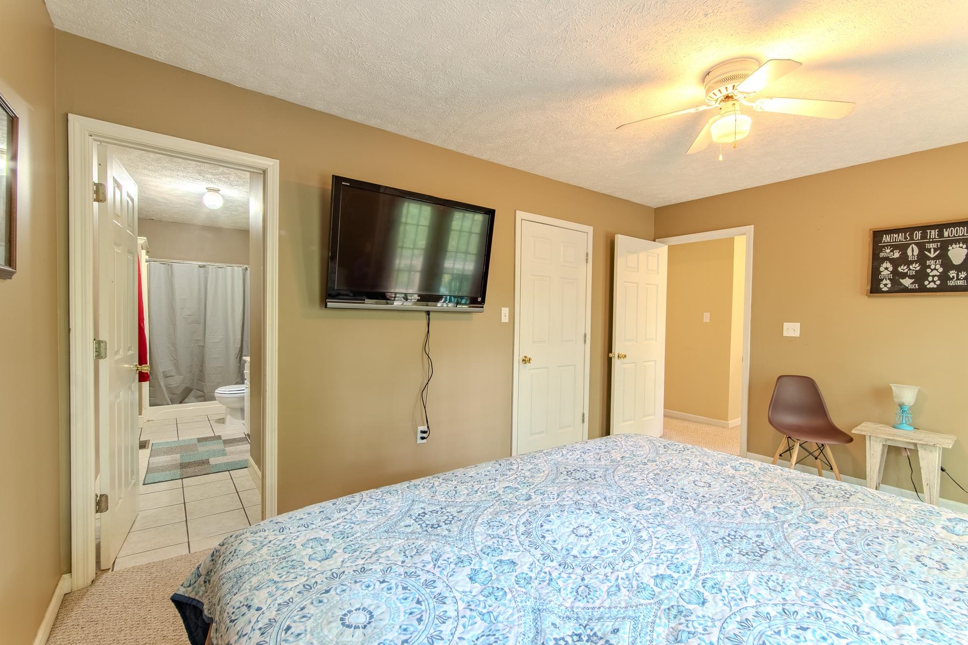 2125 Bruton Branch Road Savannah, TN 38372 - Photo 16 of 33 a bedroom with a bed and a flat tv screen on dresser