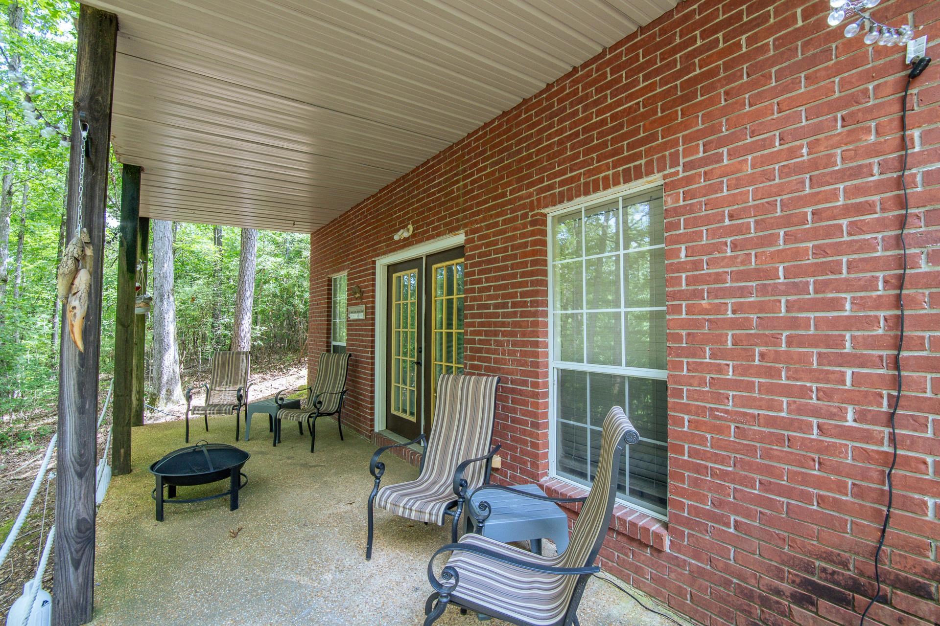 2125 Bruton Branch Road Savannah, TN 38372 - Photo 4 of 33 a view of patio with a table and chairs and floor to ceiling window