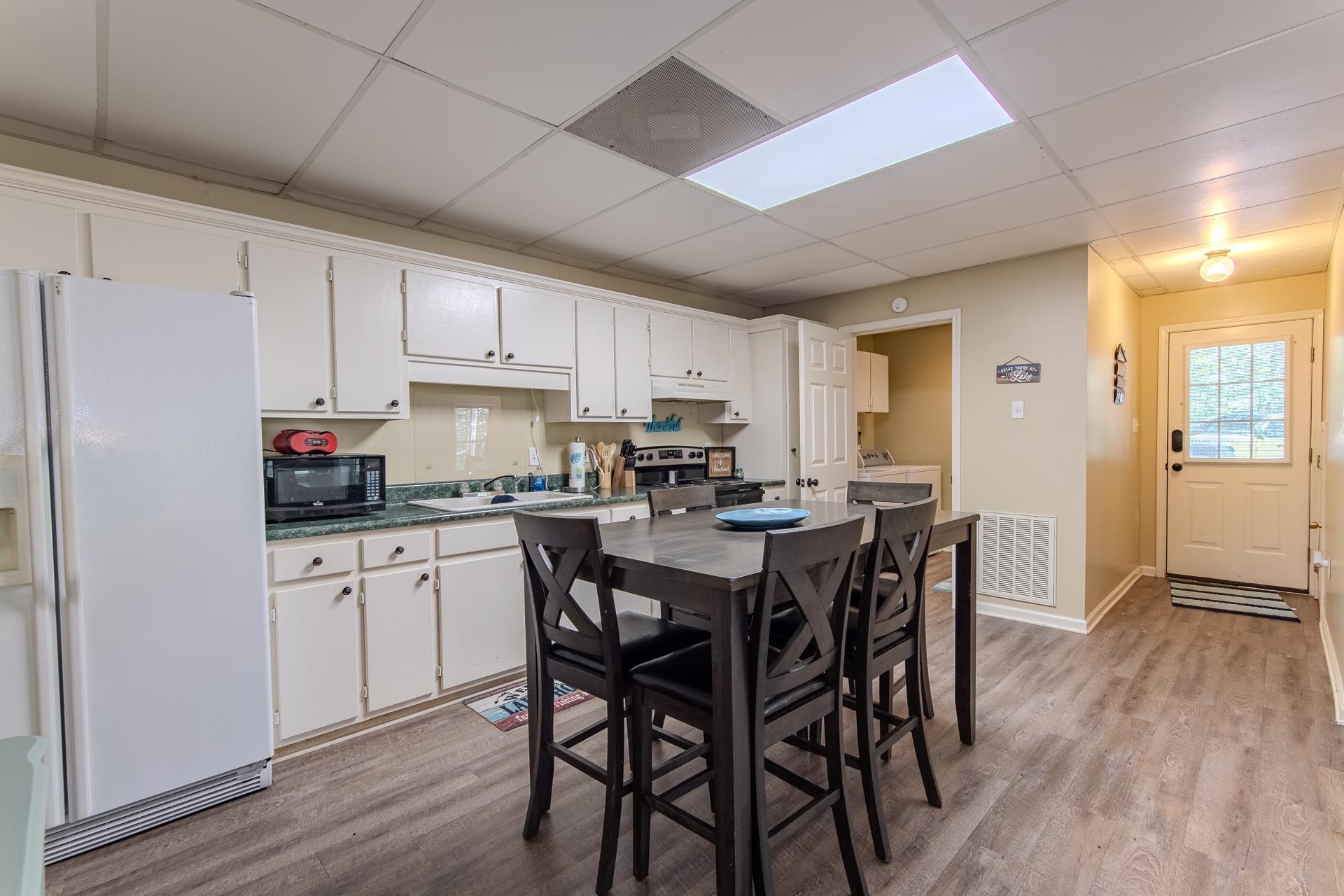 2125 Bruton Branch Road Savannah, TN 38372 - Photo 5 of 33 a kitchen with stainless steel appliances granite countertop a white table and chairs