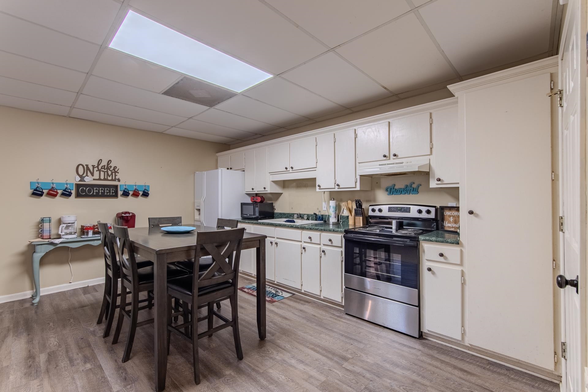 2125 Bruton Branch Road Savannah, TN 38372 - Photo 6 of 33 a kitchen with a table chairs stove and cabinets