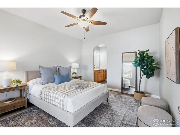 a bedroom with a large bed and a window