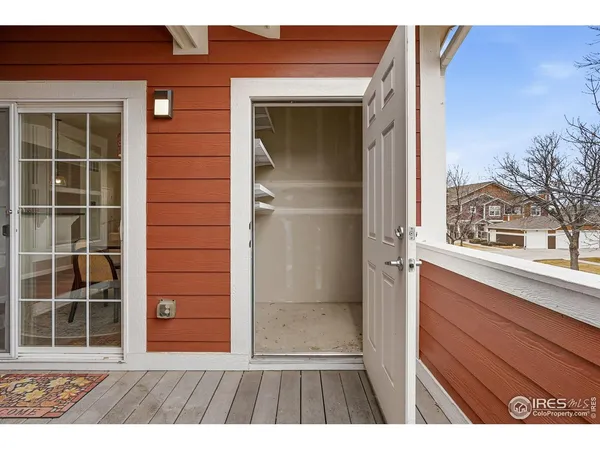 a view of entryway with shower and wooden door