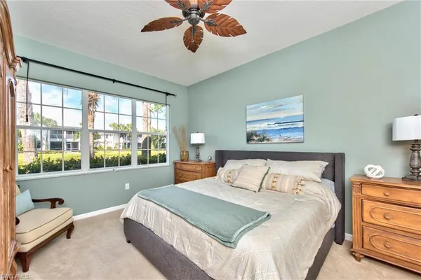 a bedroom with a large bed and a large window