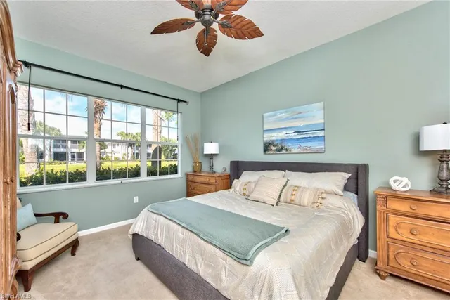 a bedroom with a large bed and a large window