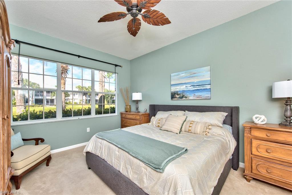 4529 Cardinal Cove Lane, Unit 7 Naples, FL 34114 - Photo 11 of 26 a bedroom with a large bed and a large window