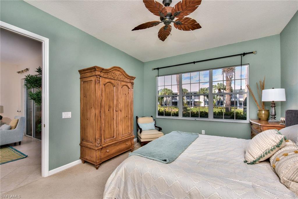 4529 Cardinal Cove Lane, Unit 7 Naples, FL 34114 - Photo 12 of 26 a bedroom with a bed and a large window with the outer view