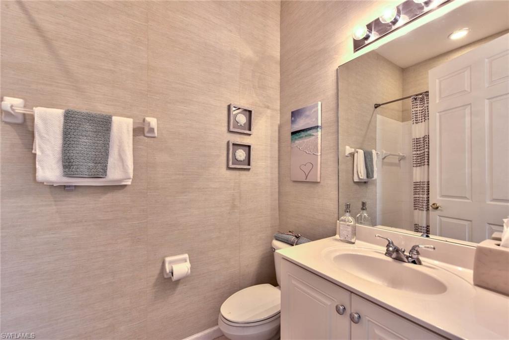 4529 Cardinal Cove Lane, Unit 7 Naples, FL 34114 - Photo 17 of 26 a bathroom with a sink a toilet and shower