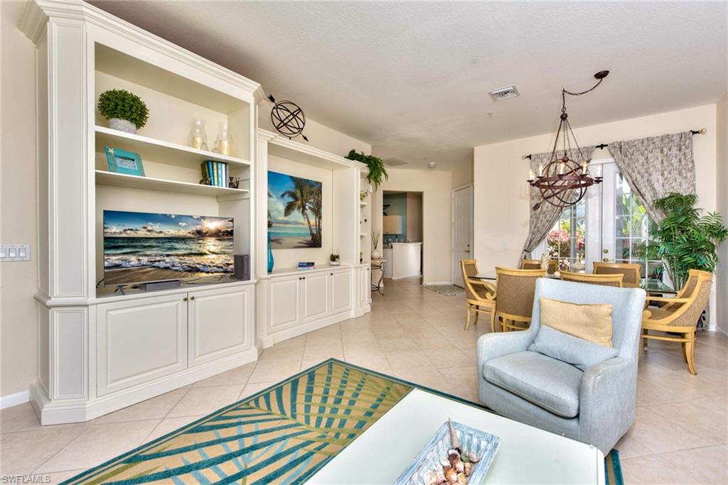 4529 Cardinal Cove Lane, Unit 7 Naples, FL 34114 - Photo 2 of 26 a living room with furniture and a window