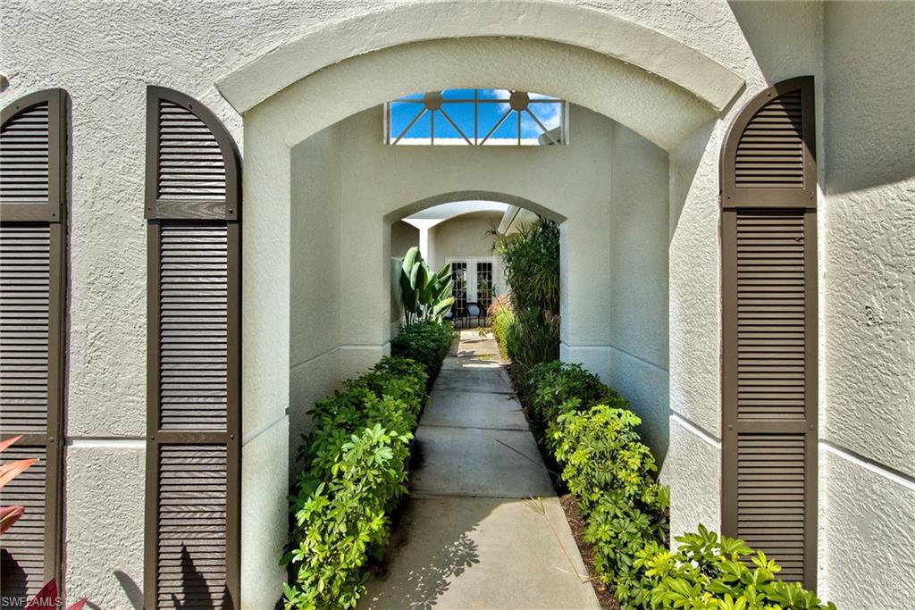4529 Cardinal Cove Lane, Unit 7 Naples, FL 34114 - Photo 21 of 26 a view of a house with a flower garden