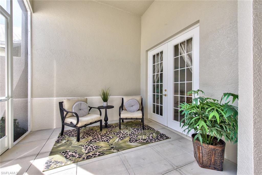 4529 Cardinal Cove Lane, Unit 7 Naples, FL 34114 - Photo 22 of 26 a living room with patio furniture