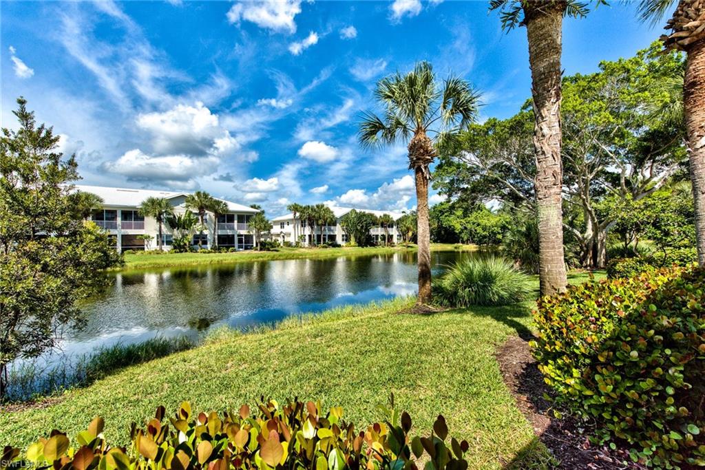 4529 Cardinal Cove Lane, Unit 7 Naples, FL 34114 - Photo 25 of 26 a view of a lake with houses