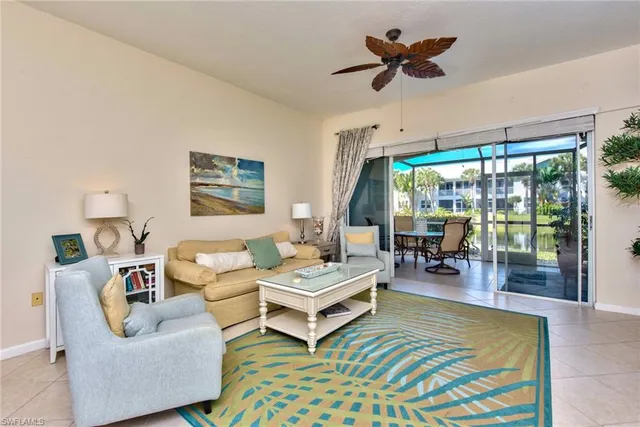 a living room with furniture a flat screen tv and a large window