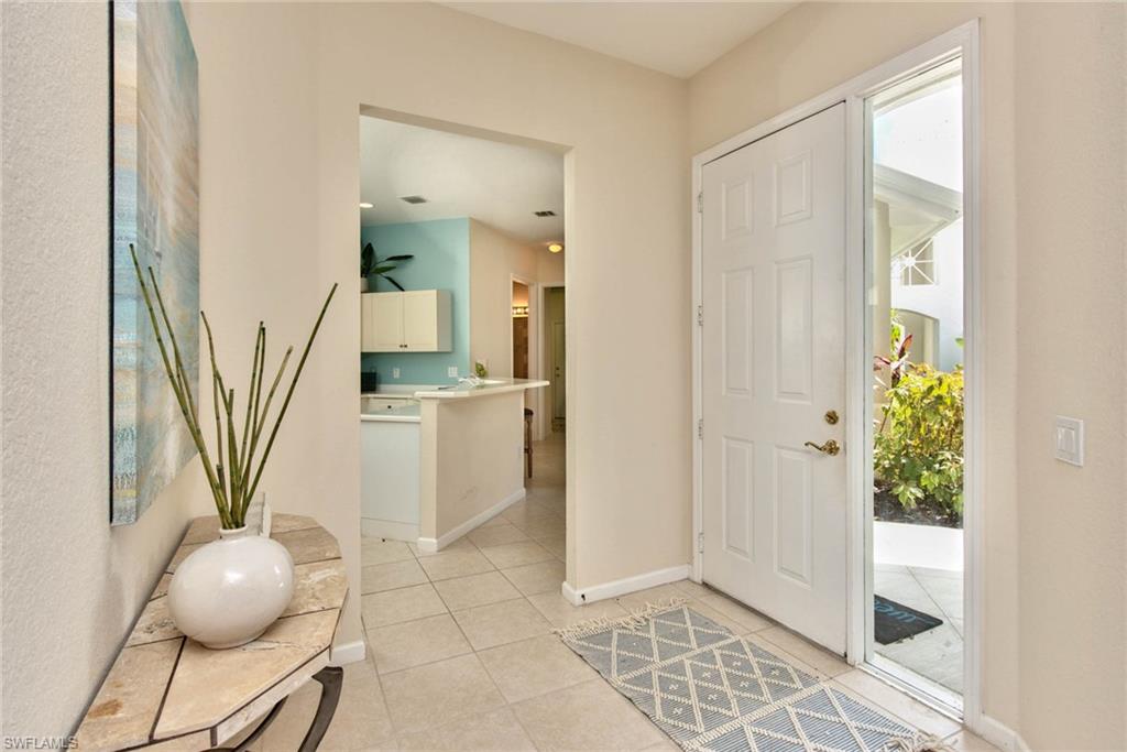 4529 Cardinal Cove Lane, Unit 7 Naples, FL 34114 - Photo 4 of 26 a view of a hallway to a livingroom with furniture