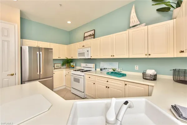 a kitchen with stainless steel appliances cabinets a sink and a stove
