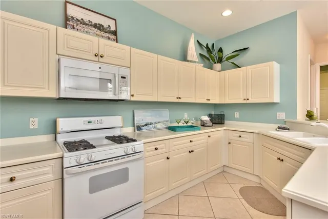 a kitchen with cabinets appliances and a sink