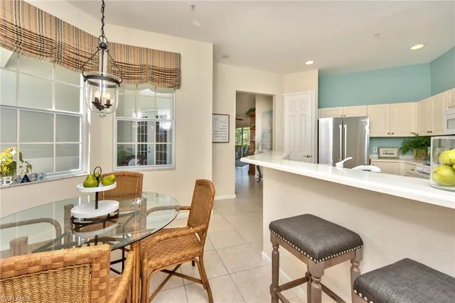 a kitchen with a table chairs and entryway