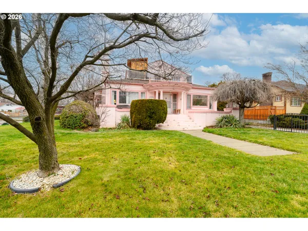a front view of a house with a garden