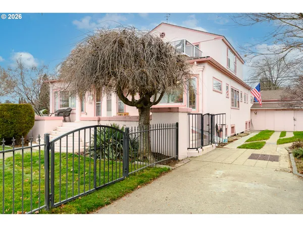 a view of a house with a small yard and plants