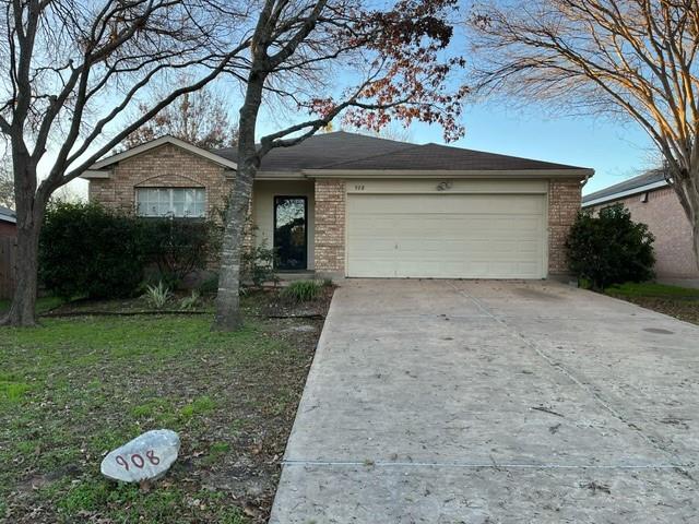 908 Rocking Spur Cove Pflugerville, TX 78660 - Photo 1 of 28 a front view of a house with a yard and garage