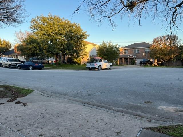 908 Rocking Spur Cove Pflugerville, TX 78660 - Photo 24 of 28 a view of a street with a cars parked in front of it