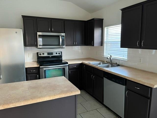 908 Rocking Spur Cove Pflugerville, TX 78660 - Photo 5 of 28 a kitchen with a sink a stove top oven and refrigerator