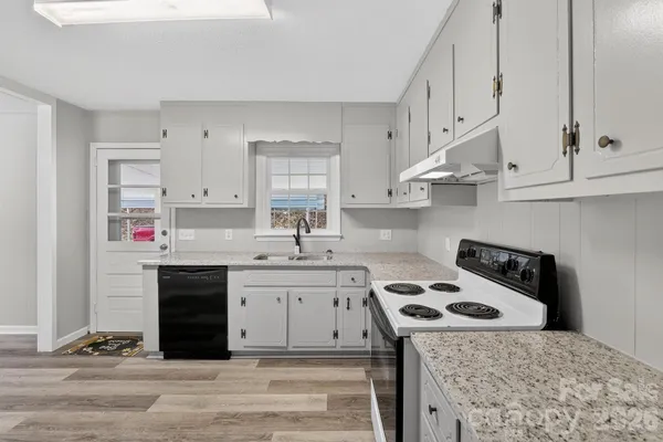 a kitchen with stainless steel appliances granite countertop a stove and a sink