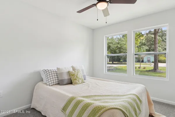 a bedroom with a bed and window