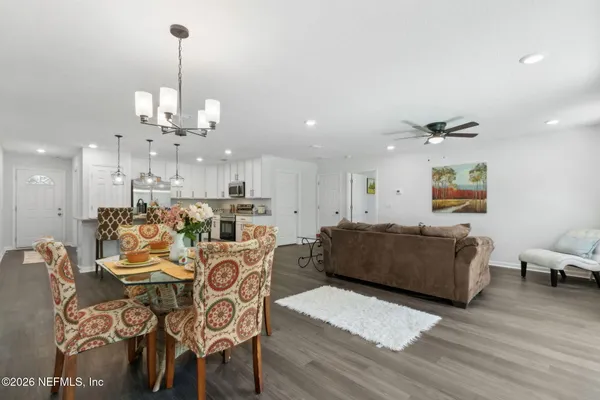a living room with furniture and kitchen view