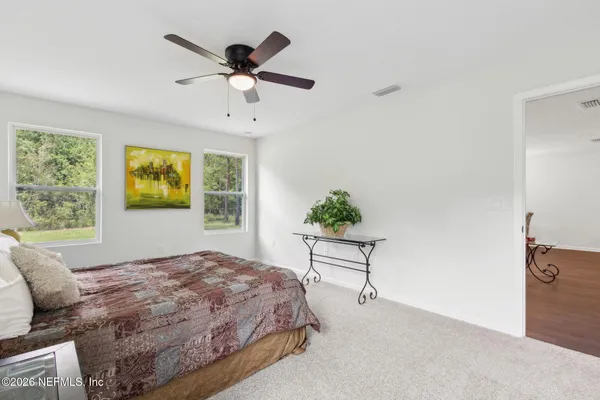 a bedroom with a bed and a table