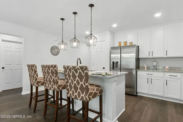 a kitchen with kitchen island granite countertop a sink a center island and cabinets