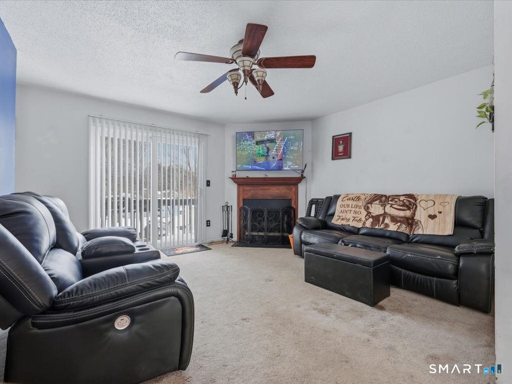 78 Woodland Ridge Meriden, CT 06450 - Photo 11 of 24 a living room with furniture and a fireplace