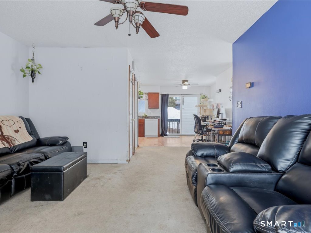 78 Woodland Ridge Meriden, CT 06450 - Photo 12 of 24 a living room with furniture and a chandelier