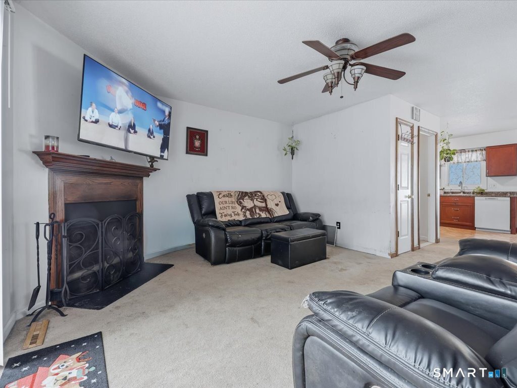 78 Woodland Ridge Meriden, CT 06450 - Photo 13 of 24 a living room with furniture and a fireplace