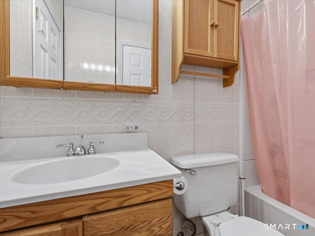 78 Woodland Ridge Meriden, CT 06450 - Photo 16 of 24 a bathroom with a sink a toilet and a mirror