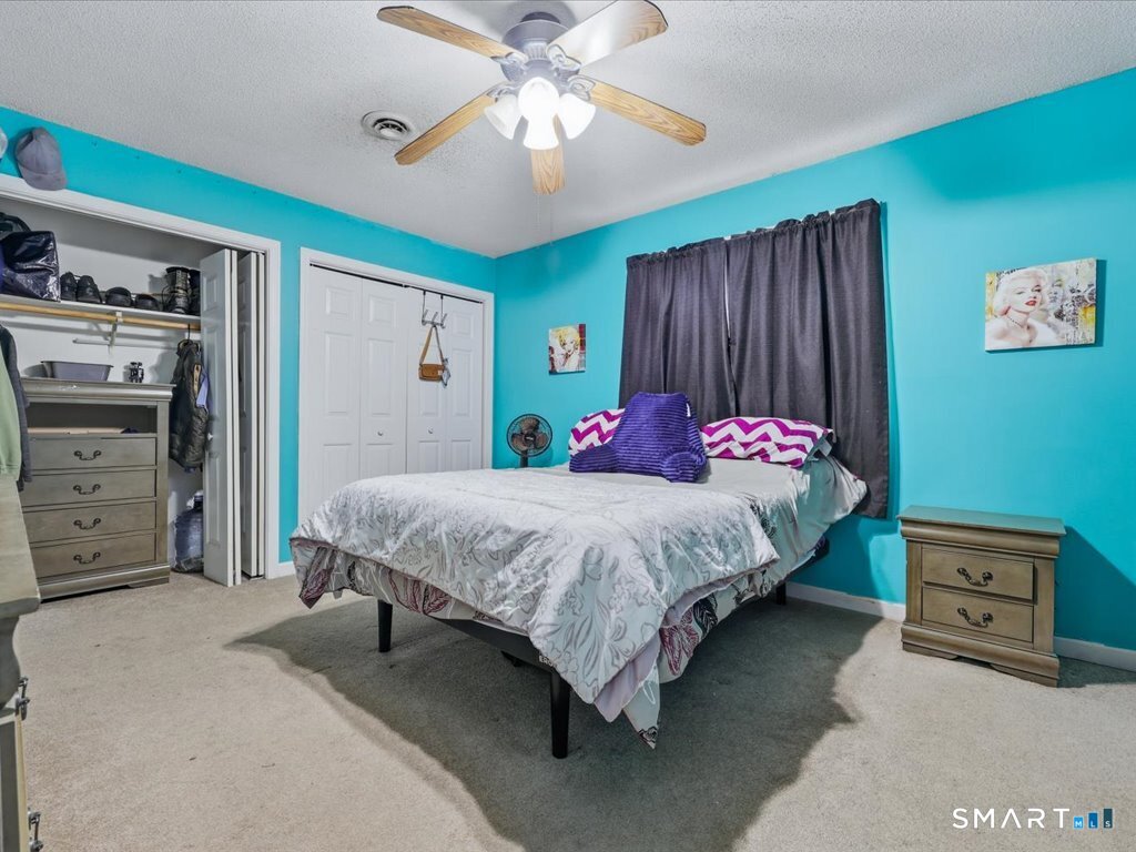 78 Woodland Ridge Meriden, CT 06450 - Photo 17 of 24 a bedroom with a bed and a tv