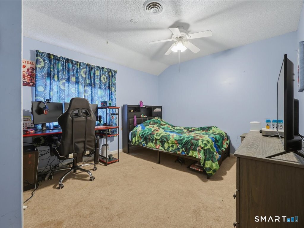 78 Woodland Ridge Meriden, CT 06450 - Photo 19 of 24 a bedroom with bed and a chandelier