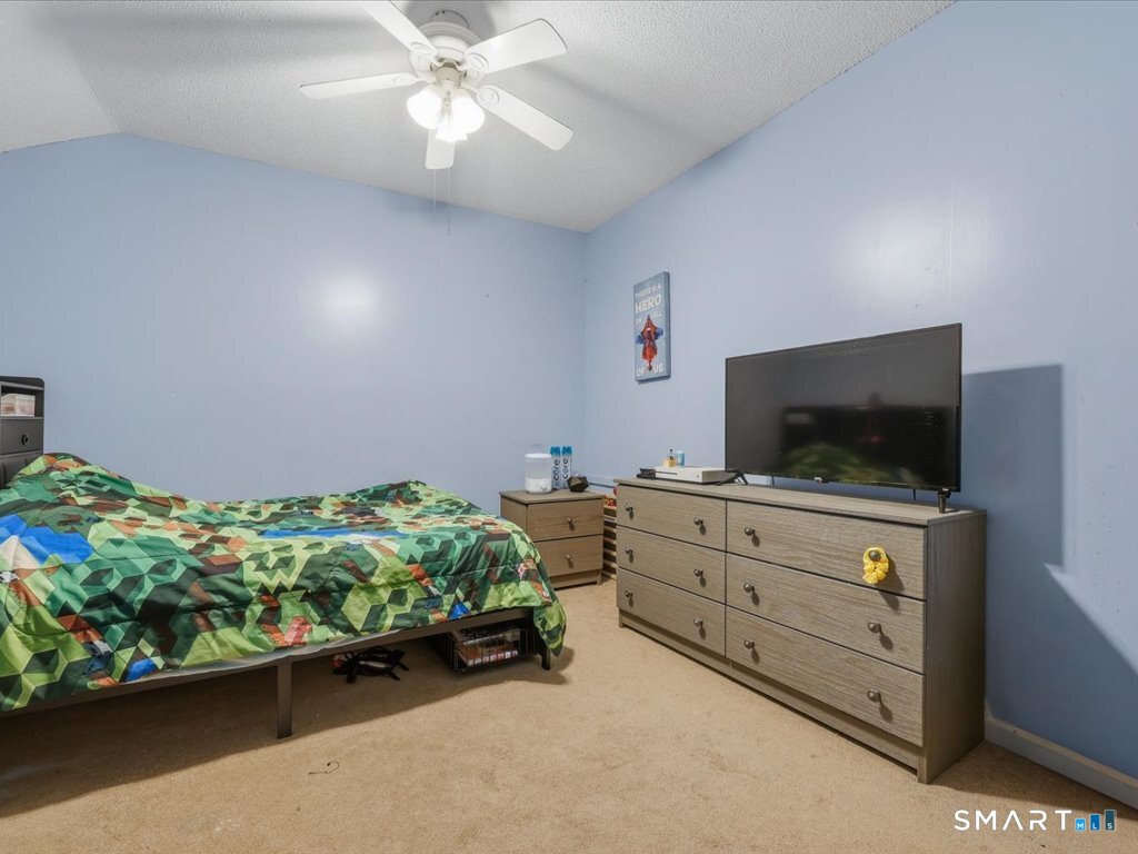 78 Woodland Ridge Meriden, CT 06450 - Photo 20 of 24 a bedroom with furniture and a flat screen tv