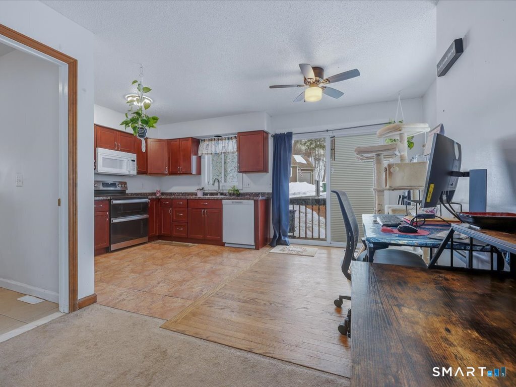78 Woodland Ridge Meriden, CT 06450 - Photo 3 of 24 a living room with stainless steel appliances furniture a chandelier and a dining table