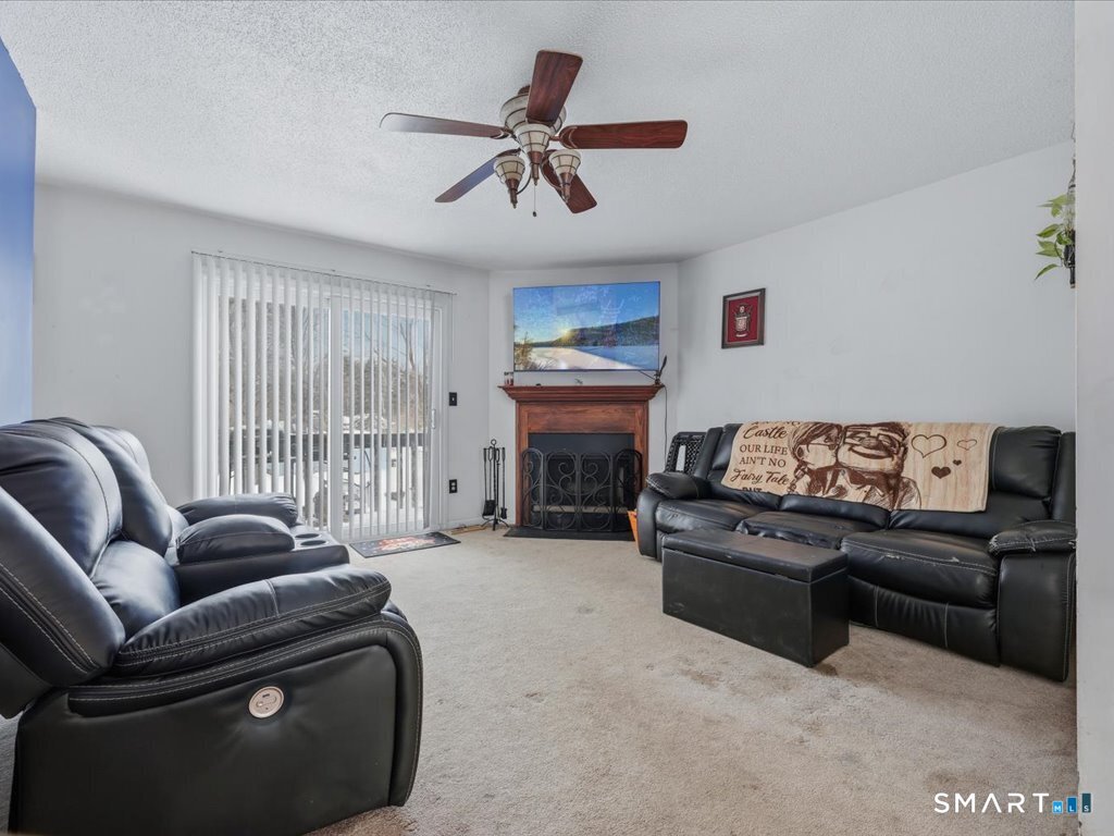 78 Woodland Ridge Meriden, CT 06450 - Photo 9 of 24 a living room with furniture and a fireplace