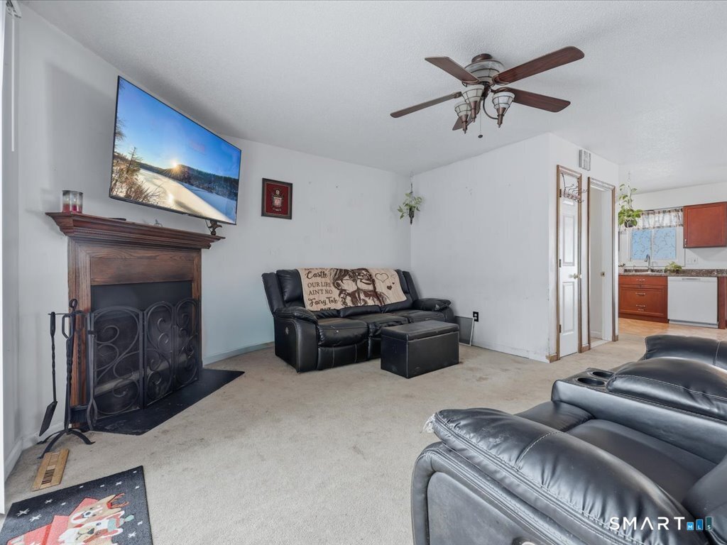 78 Woodland Ridge Meriden, CT 06450 - Photo 10 of 24 a living room with furniture and a fireplace
